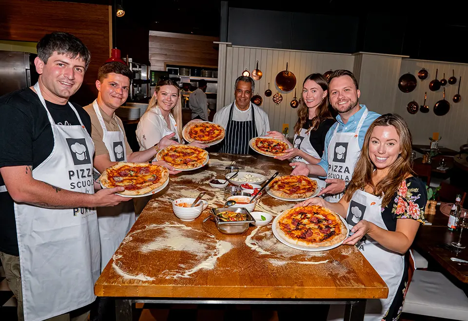 Students creating homemade pizza's from Pizza Scuola, Ponti's Oxford Circus, London